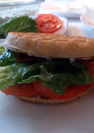 A picture of Waffle BLT's with a tangy herb sauce.