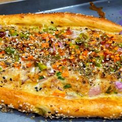 Turkish veggi pide with egg A picture of Turkish veggi pide with egg.