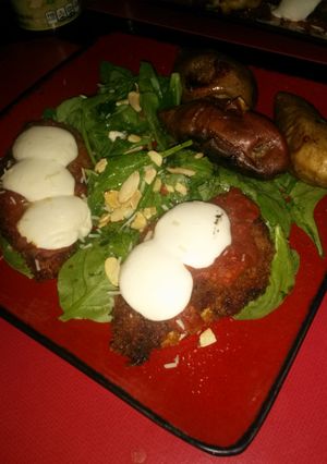 A picture of Panko-fried chicken breast marinara with baked sweet potato and spinach.