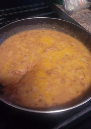 A picture of Mexican style bacon cheese refried beans.