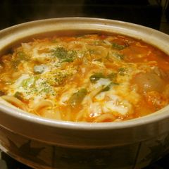 A picture of Simmered Udon Noodle Hot Pot with Melting Cheese and Tomato.