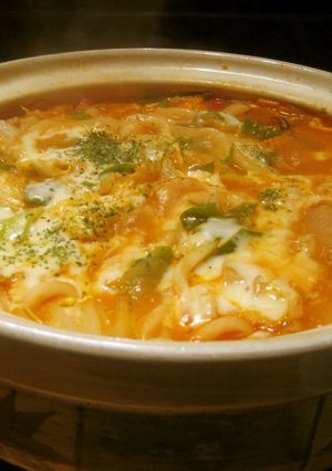 A picture of Simmered Udon Noodle Hot Pot with Melting Cheese and Tomato.