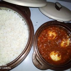 A picture of Rice and stew with boiled eggs.