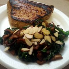 A picture of Paleo Seared tuna with citrus marinade and sauted spinach with mushrooms, onions, and bacon.