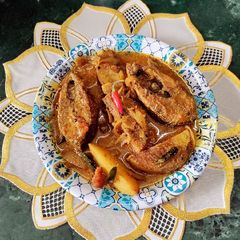A picture of Hilsa Fish Curry With Mustard Paste.