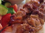 A picture of souvlaki with tzatziki
