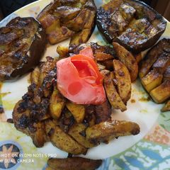 A picture of Stuff Brinjal with potato wedges.