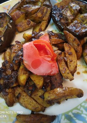 A picture of Stuff Brinjal with potato wedges.