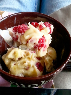 A picture of Banana ice cream with frozen raspberries.