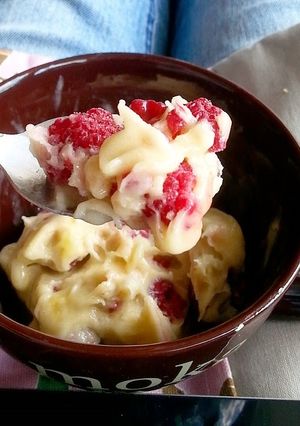 A picture of Banana ice cream with frozen raspberries.