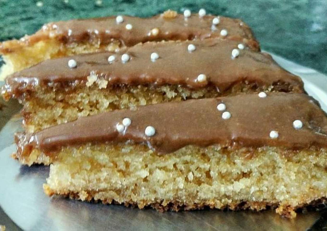 Coconut Rava cake topped with chocolate and silver balls