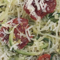 A picture of Zucchini and squash "pasta" with pesto and sun dried tomatos.
