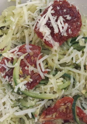 A picture of Zucchini and squash "pasta" with pesto and sun dried tomatos.