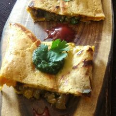 A picture of Paneer bhurji stuffed besan chilla.
