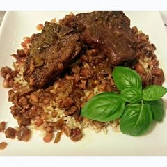 A picture of Lamb Fesenjan- Lamb with Pomegranate Walnut Sauce.