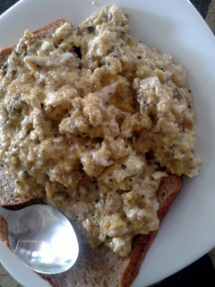 A picture of Scrambled eggs with whole grain toast.
