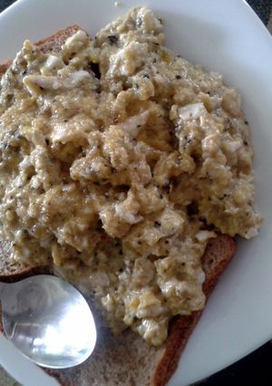 A picture of Scrambled eggs with whole grain toast.
