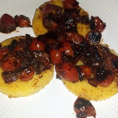 A picture of Polenta with balsamic blistered tomatoes.
