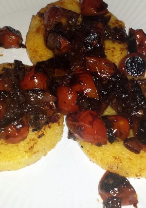 A picture of Polenta with balsamic blistered tomatoes.