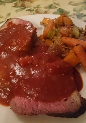 A picture of Slow-Cooked Roast Beef with Red Sauce.