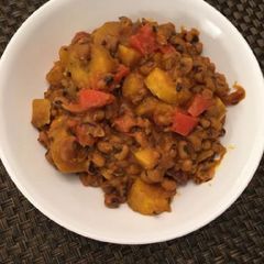 A picture of Porriage beans with ripe plantain and fresh tomatoes.