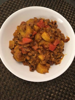 A picture of Porriage beans with ripe plantain and fresh tomatoes.