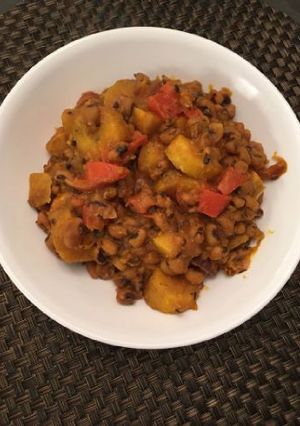 A picture of Porriage beans with ripe plantain and fresh tomatoes.
