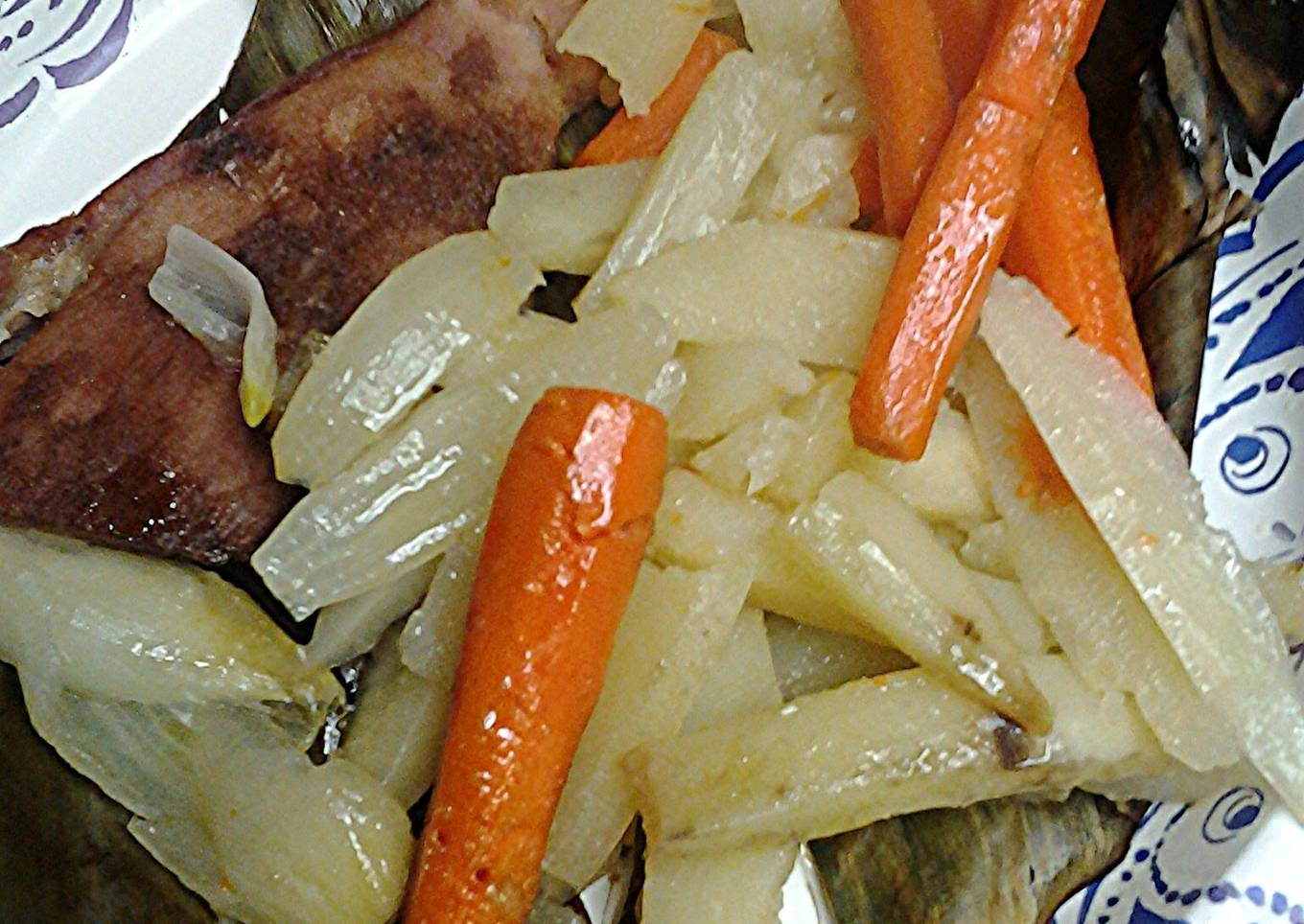 Fried potatoes and carrots on banana leaves