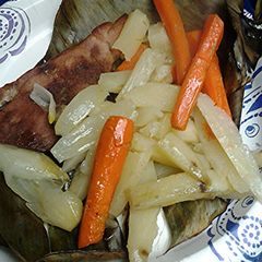 A picture of Potatoes and carrots roasted in banana leaf.