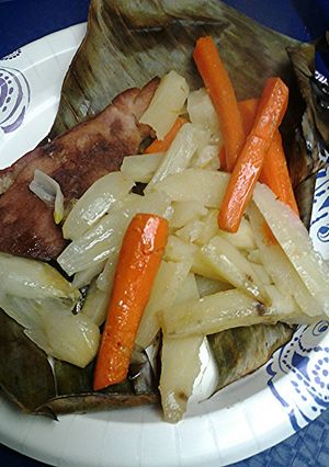 A picture of Potatoes and carrots roasted in banana leaf.