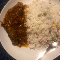 A picture of White rice and chicken curry.
