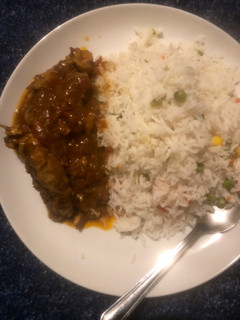 A picture of White rice and chicken curry.