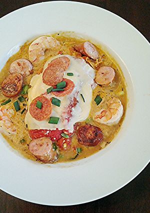 A picture of Roasted Red Peppers Stuffed with pasta in a Garlic Broth.