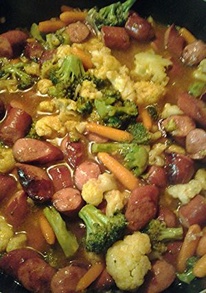 A picture of Stir fry hotdogs and veggies.