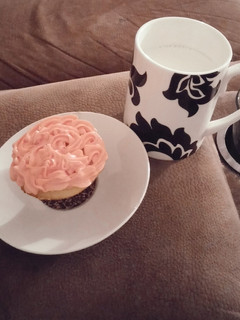 A picture of White cake mix cup cakes with strawberry frosting..