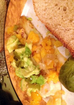 A picture of Talipia With Orange, Avocado, Onions, Yellow Peppers And Jalepenos.
