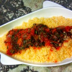 A picture of Steamed cous-Cous with spinach stew.