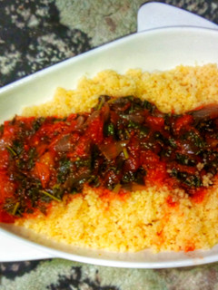 A picture of Steamed cous-Cous with spinach stew.