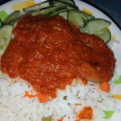 A picture of White rice with carrot stew.