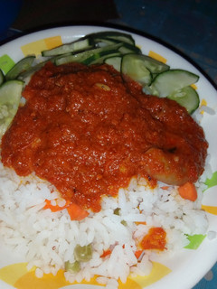 A picture of White rice with carrot stew.