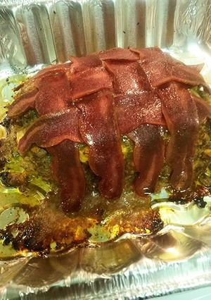 A picture of Beef Meatloaf wrapped in Turkey bacon.