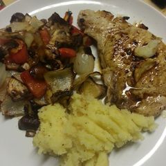 A picture of Pork chop, mashed potato and roasted veg.