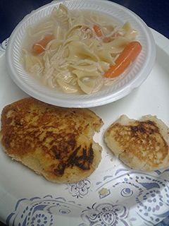 A picture of Chicken noodles with fried bread.