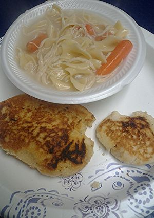 A picture of Chicken noodles with fried bread.