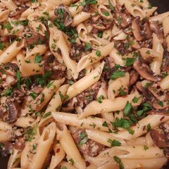 A picture of Penne with mushrooms.
