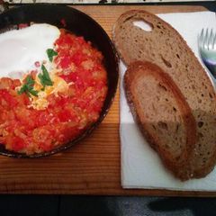 A picture of Easy eggs and tomatoes breakfast dish (shakshuka).