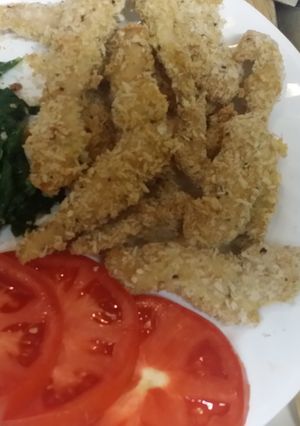 A picture of Turkey Cutlets with sautéed spinach and tomato slices.