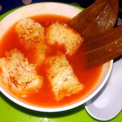 A picture of Tomato, carrot soup.