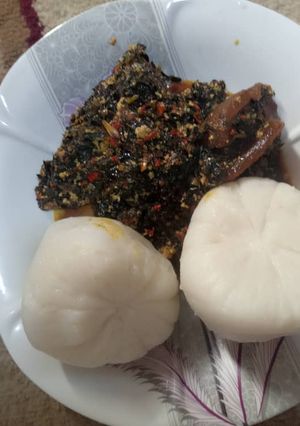A picture of Tuwon Rice with ugwu and water leaf soup.