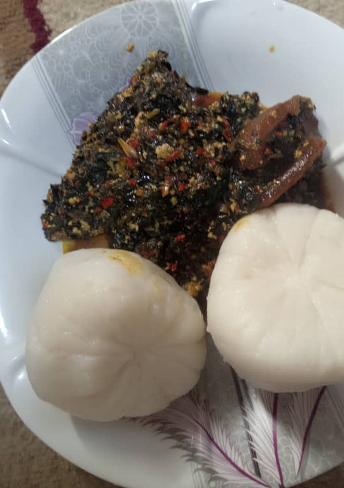 A picture of Tuwon Rice with ugwu and water leaf soup.